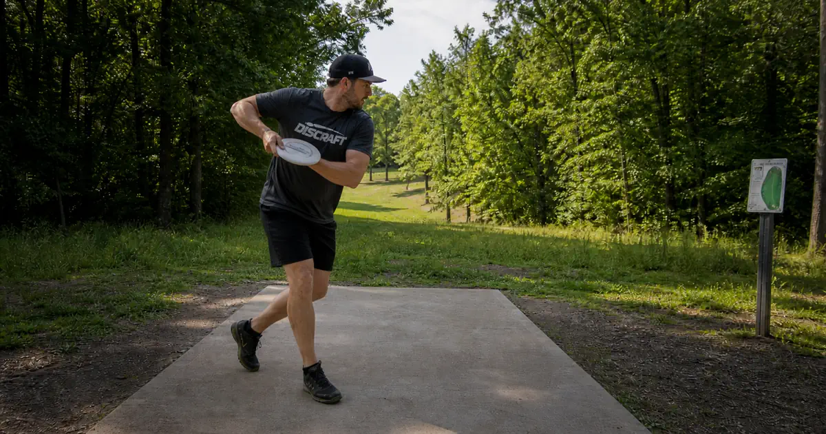Disc golf power pocket position with elbow forward and disc close to chest during pull through